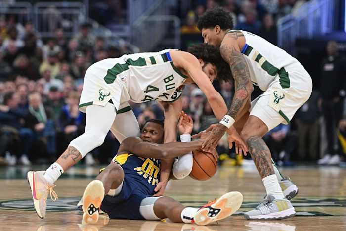 Indiana Pacers center Bennedict Mathurin (00) battles for a loose ball against Milwaukee Bucks guard Andre Jackson Jr. (44) with MarJon Beauchamp